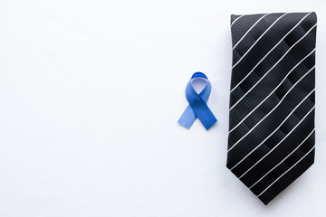 symbol of prostate cancer and tie on a white background