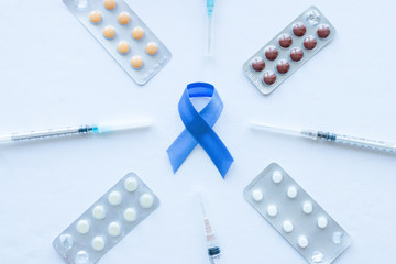 medicines and blue ribbon symbol of prostate cancer