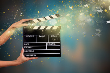 Clapperboard sign hold by female hands.