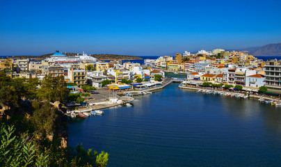 Naklejka na ściany i meble The lake Voulismeni in Agios Nikolaos, a picturesque coastal town with colorful buildings around the port in the eastern part of the island Crete, Greece