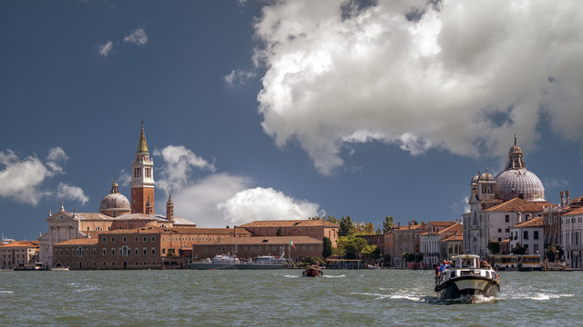 Beautiful panoramic view of Giudecca and San Giorgio Maggiore on a sunny day with picturesque sky, Venice, Italy