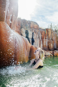 Cheerful Woman Splashing Water In Pond