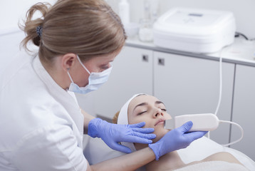 Fototapeta premium Ultrasound cavitation, face skin cleansing