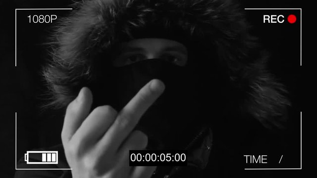 the masked robber shows on a hidden camera the middle finger