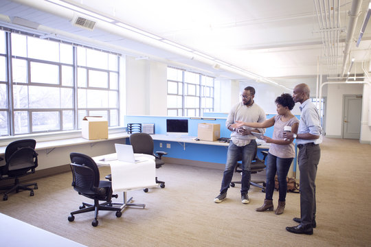 Business People Talking While Standing In Office