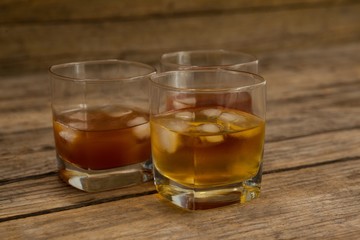 Three glasses of whiskey with ice cube