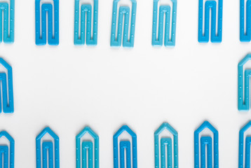 many blue paper clip on a white paper sheet with space for text