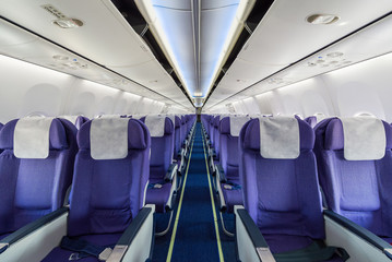 Empty passenger airplane seats in the cabin - Powered by Adobe