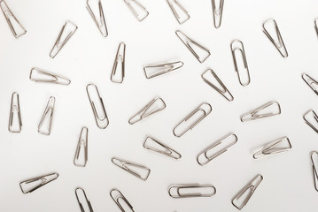 many paper clips on a white background