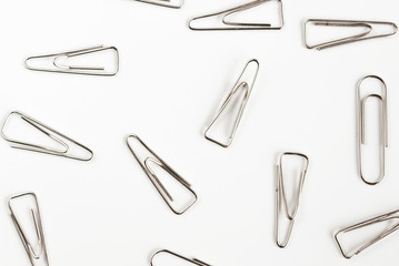 many paper clips on a white background