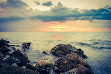 Landscape photo of rocks in the sea in sunset - retro vintage filter effect