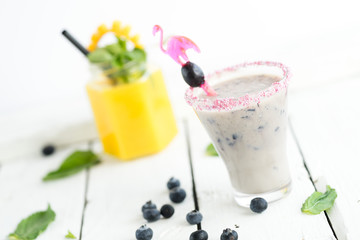 modern rustic selection of cocktails drinks alcohol at bar counter with defocused background various colours glass