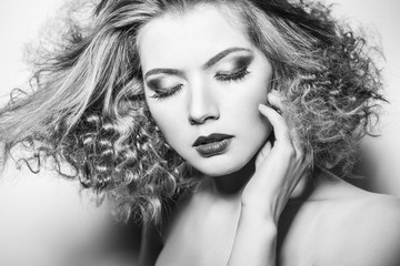 Portrait of beautiful model with luxuriant hair curling.