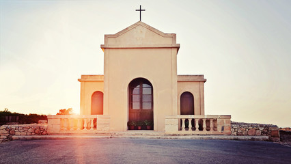 View of the small ancient chapel in the rays of sunset, Chapel of Immaculate Conception