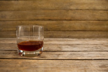 Glass of whisky on wooden table