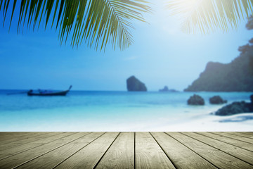 Fototapeta na wymiar Blurred beach background with palm tree and empty wooden.