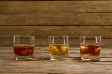 Three glasses of whiskey with ice cube