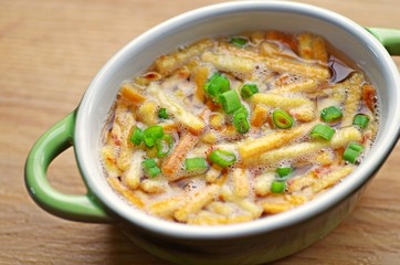 Bowl of Frittaten or egg with fresh organic chive cutting on top for breakfast in the morning. Top view.