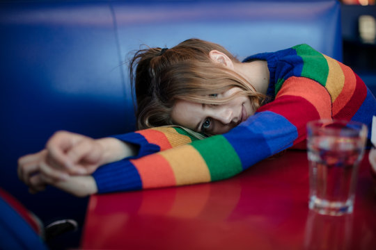 Shy girl in a rainbow sweater