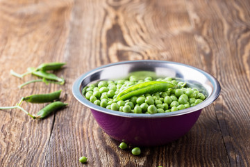 Raw organic green peas in  bowl