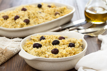 portuguese dish cod fish with potato and eggs on dish