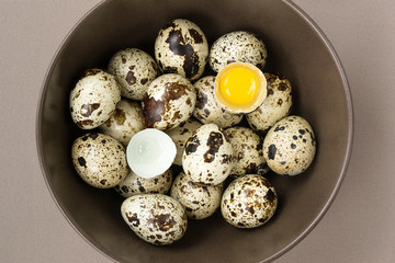 Quail eggs in plates, one egg is broken
