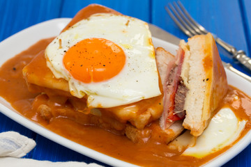 portuguese sandwich francesinha with fried egg