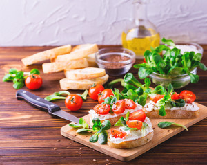 Bruschetta with ricotta, spinach, corn salad and cherry tomatoes