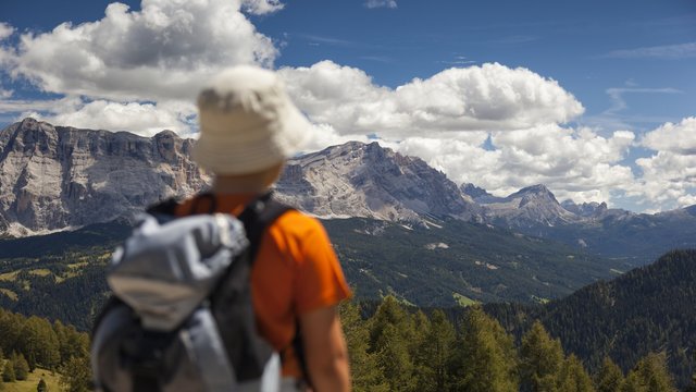 Little hiker admires the Sasso della Croce mountain, Val Badia, dolomites, Italy