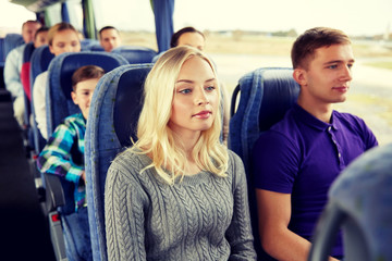 happy couple or passengers in travel bus