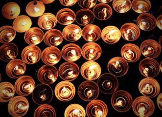 candles lit with the warm flame during the religious ceremony