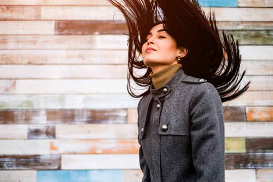 Brunette Girl Outdoor With Blowing Up Hair