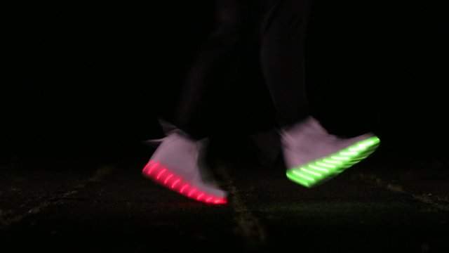 closeup of feet to dance in shoes that glow in the night