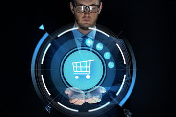 businessman with virtual shopping cart projection