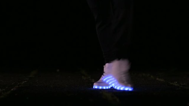 closeup of feet to dance in shoes that glow in the night