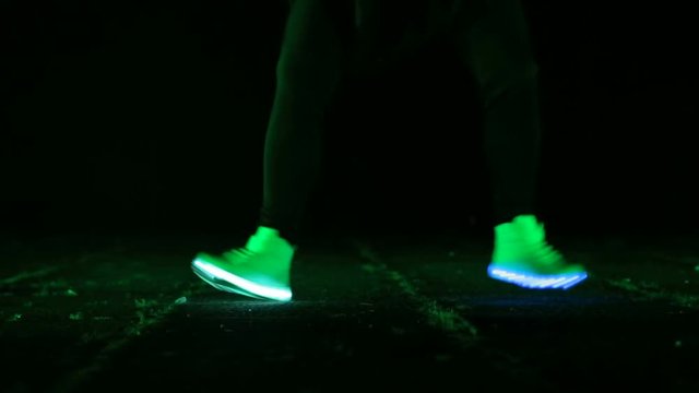 closeup of feet to dance in shoes that glow in the night
