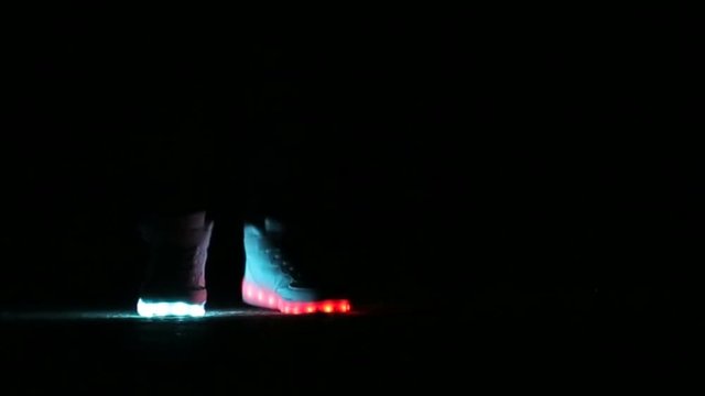 closeup of feet to dance in shoes that glow in the night