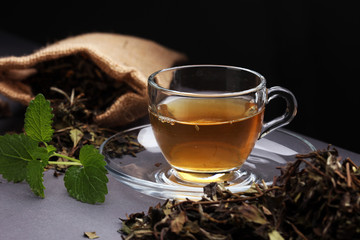 Herbal dry sri lanka tea. Mint leaf. Tea in a glass cup, mint leaves, dried tea, in a restaurant or teahouse