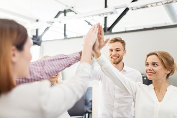 happy business team making high five at office
