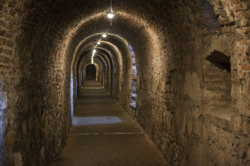 Fototapeta na wymiar Long dark corridor walls under ground with natural lights Budapest Castle Hill