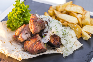 roast potatoes and veal on a plate