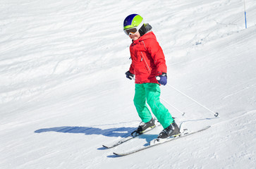 Fototapeta na wymiar Little skier exercising in alpine resort