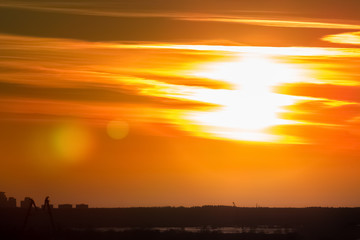 Obraz premium Gold sunset sky against town silhouette in Riga, Latvia