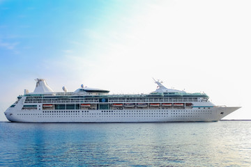 White cruise ship underway. Passenger ship leaving port of Riga
