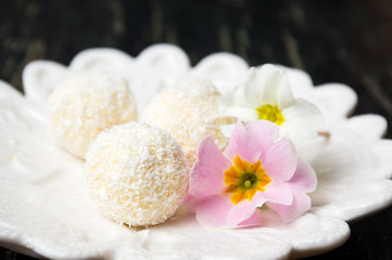 Obraz na płótnie Canvas Coconut dessert balls on a plate