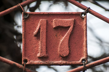 Old retro weathered cast iron plate with number 17 - obrazy, fototapety, plakaty