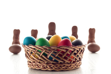 Colorful Easter eggs close-up macro on a white wooden table. The concept of a holiday and a happy Easter.