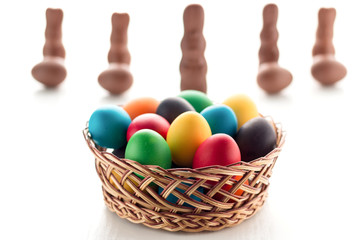 Colorful Easter eggs close-up macro on a white wooden table. The concept of a holiday and a happy Easter.