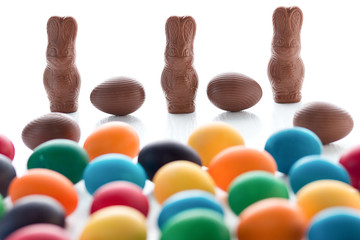 Colorful Easter eggs close-up macro on a white wooden table. The concept of a holiday and a happy Easter.