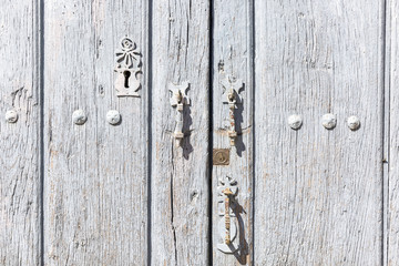 gray wooden door with ancient metallic ornaments